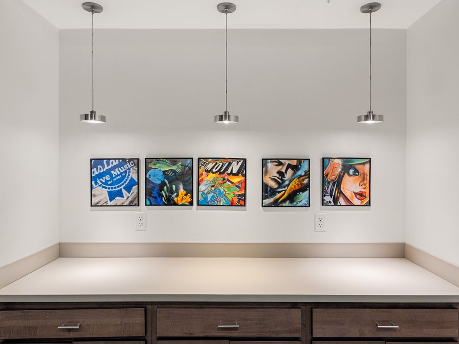 Wall of original paintings by local Des Moines artists in a Harbach Lofts common area