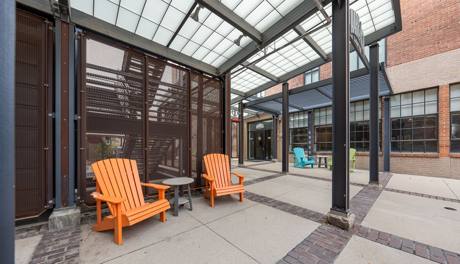 The dimensional Harbach Lofts sign over the courtyard entrance