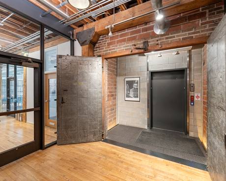The original riveted steel freight door, still on its hinges